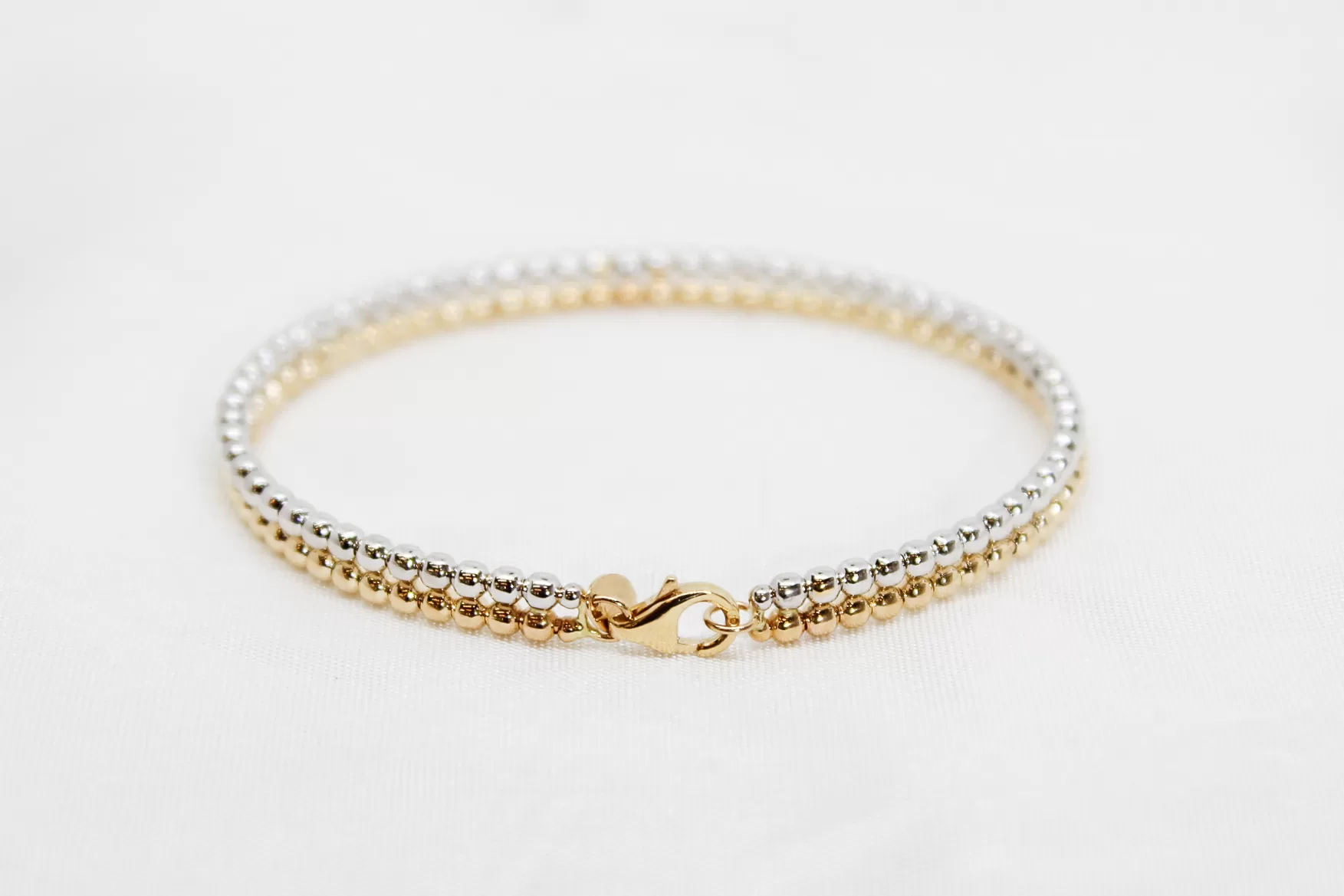 Pulseira em ouro bicolor escrava às bolinhas