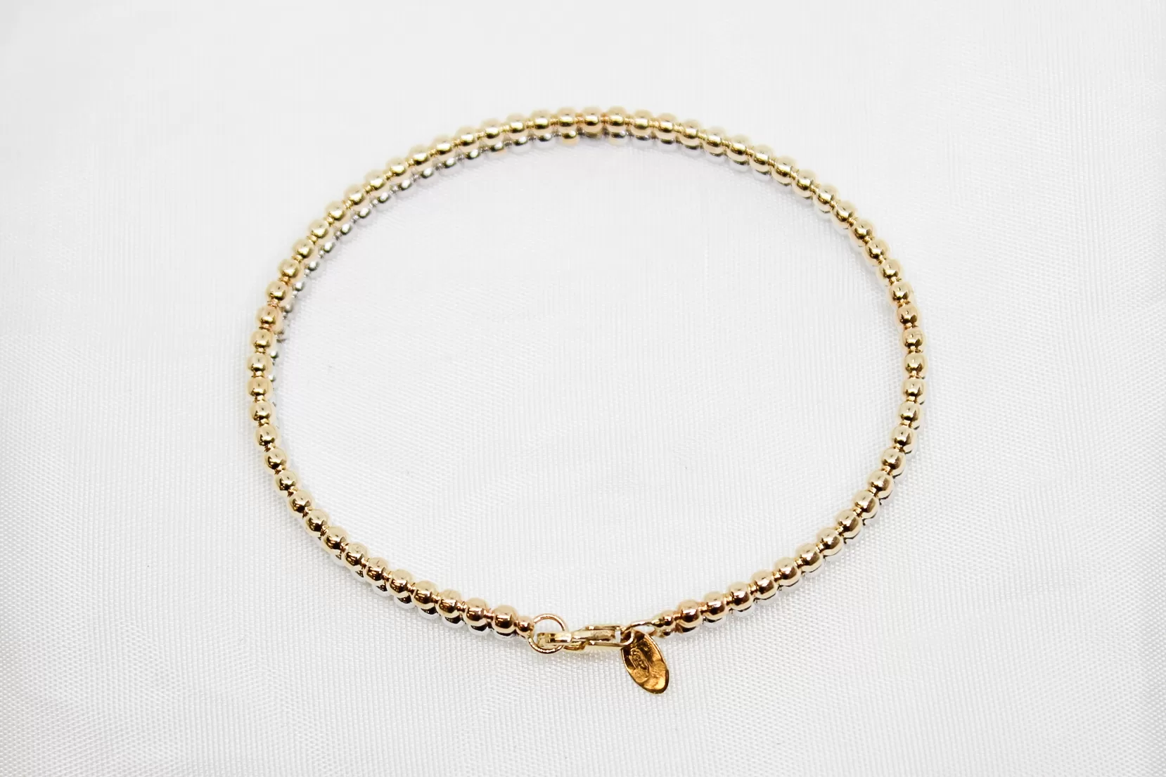 Pulseira em ouro bicolor escrava às bolinhas