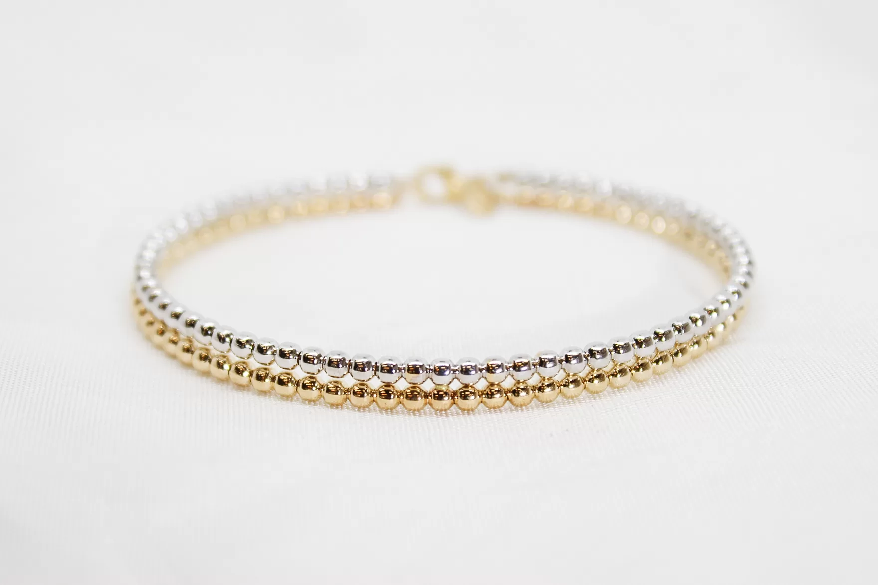 Pulseira em ouro bicolor escrava às bolinhas